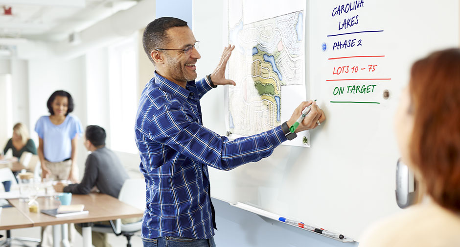 Man writing on a Invisamount Board