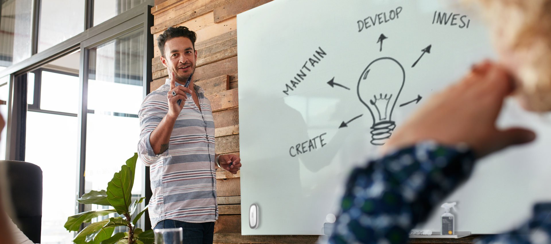 Man writing on a Quartet whiteboard